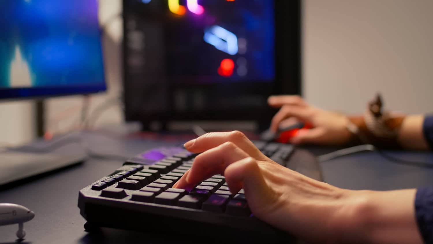 close up of gamer using rgb keyboard and mouse for online competition